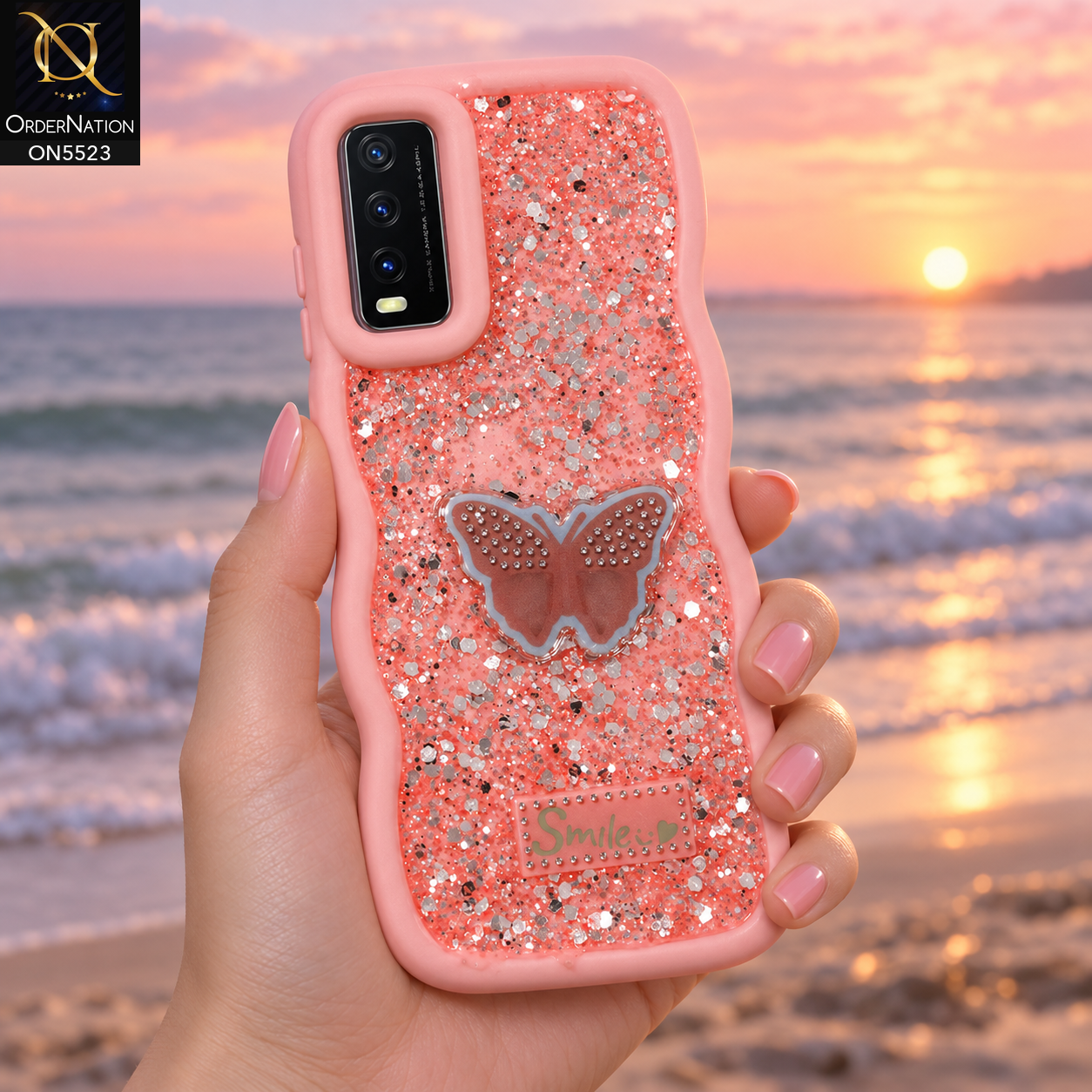 Vivo Y20T Cover - Pink - New Premium Smile Glitter Soft Case on the phone, held in a hand on a beach at sunrise (AI lifestyle render)