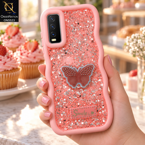 Vivo Y20i Cover - Pink - New Premium Smile Glitter Soft Case on the phone, held in a hand at a bakery counter with cupcakes (AI lifestyle render)