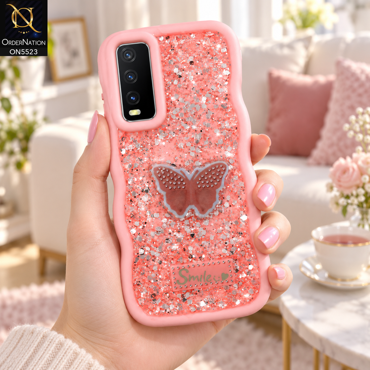 Vivo Y20s Cover - Pink - New Premium Smile Glitter Soft Case on the phone, held in a hand in a bright living room (AI lifestyle render)